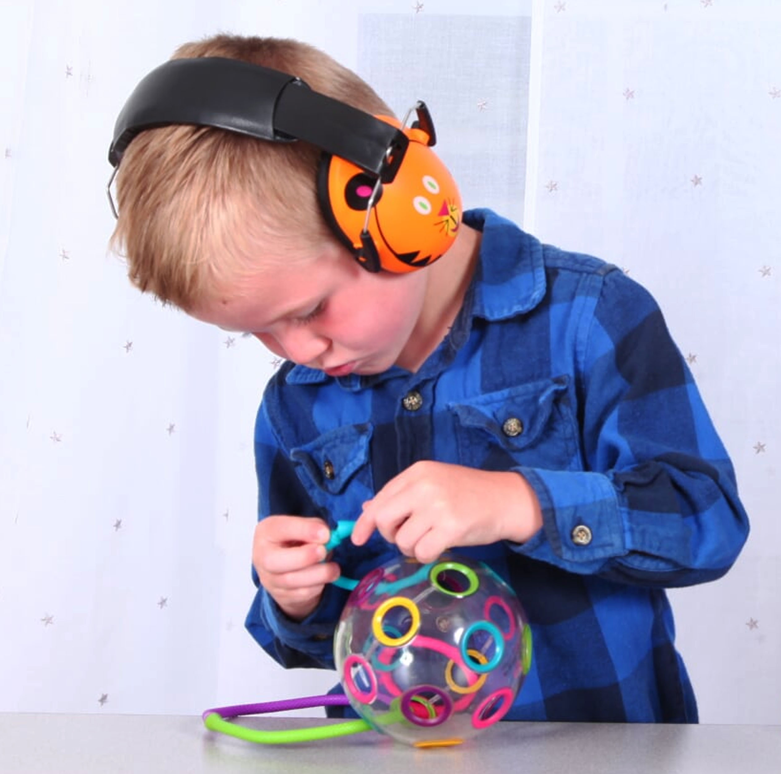 boy playing with fidget ball yarn string